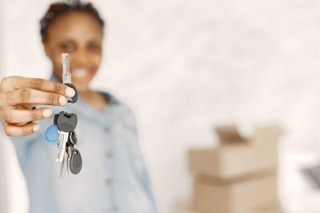 a person holding up a house key